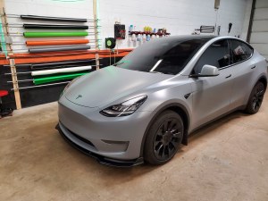 Tesla Model 3 receiving a custom 3M Satin Black vinyl wrap at The Wrench Shack in Naperville IL